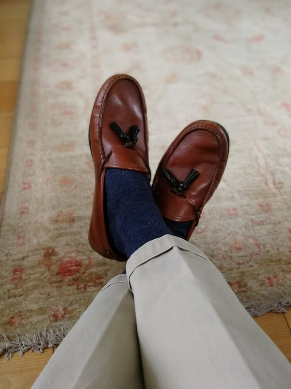 Brown leather loafers with  beige chinos and navy socks