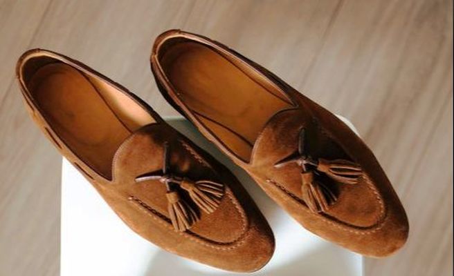 Brown_suede_penny_loafers_on_white_table